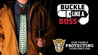 Person holding a pitchfork wearing a necktie with the words "Buckle like a boss"