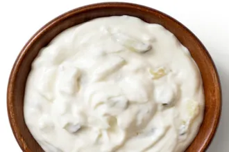 Wooden bowl of cucumber yogurt and cream cheese dip