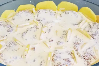 Baking dish with potato beef casserole ready to cook.