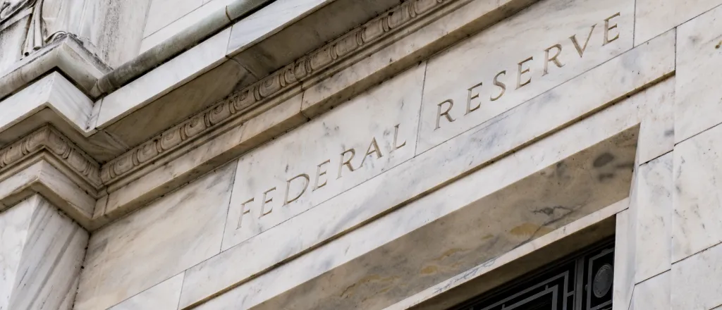 Stone building with the words "Federal Reserve" over a doorway
