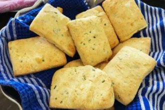 Cloth holding eight parmesan chive biscuits