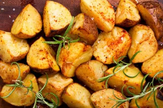 Herb roasted potatoes with sprigs of rosemary