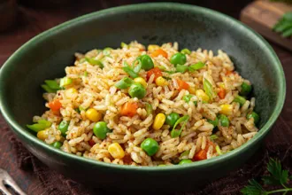Rounded bowl with three semi-flattened sides of vegetable fried rice.