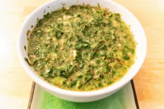 Overhead view of a bowl of chimichurri sauce.