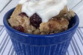 Close up view of bread pudding with vanilla sauce
